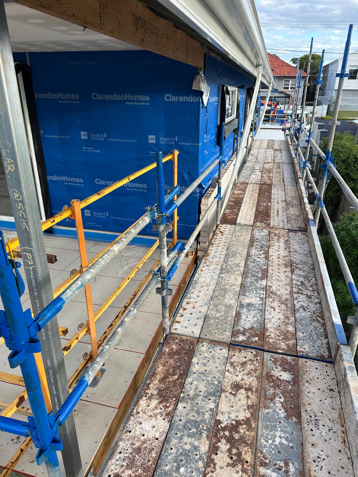 Detailed scaffolding platforms and bracing at a construction site